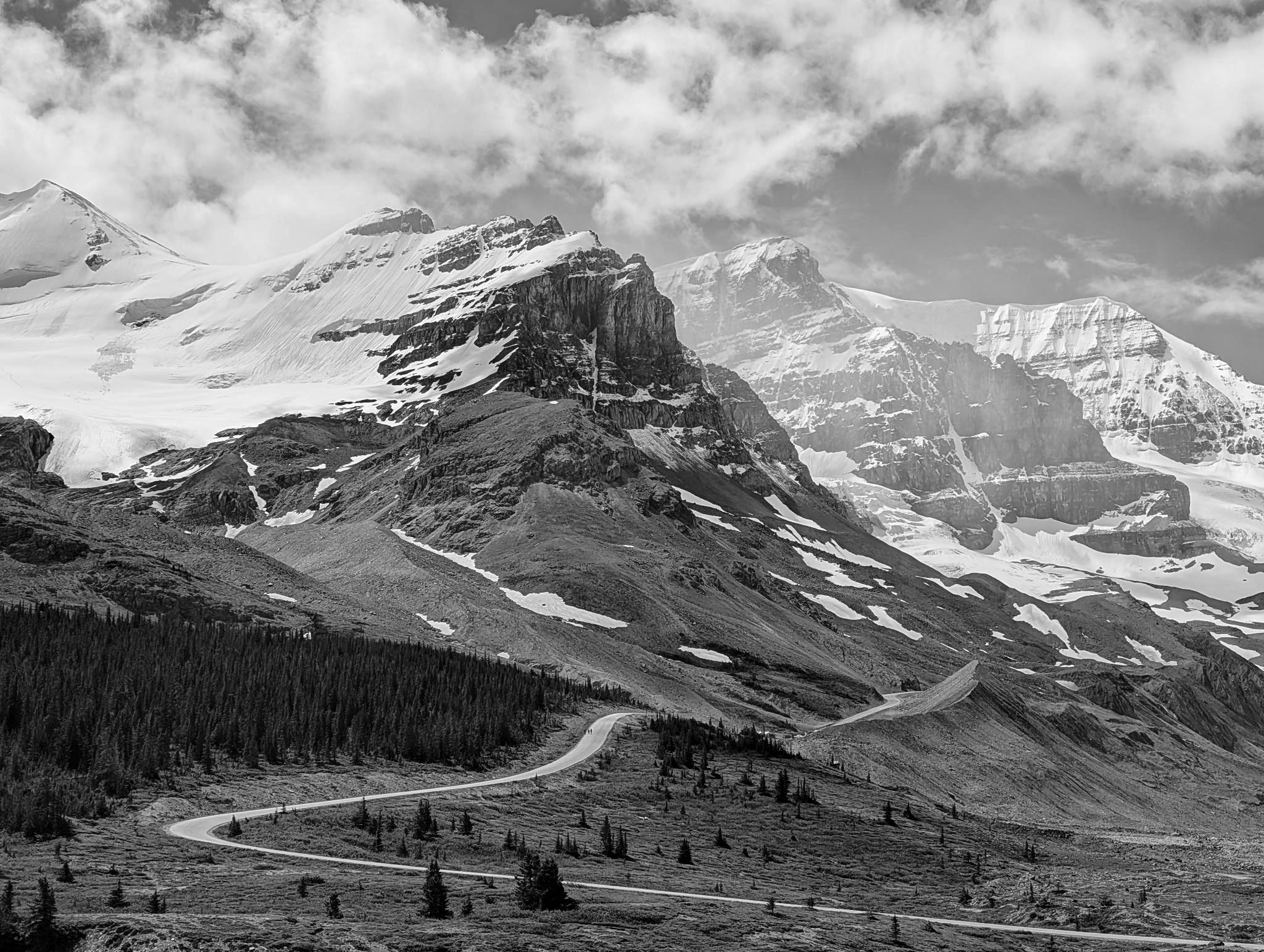 Mountains with ice and a winding road in the front